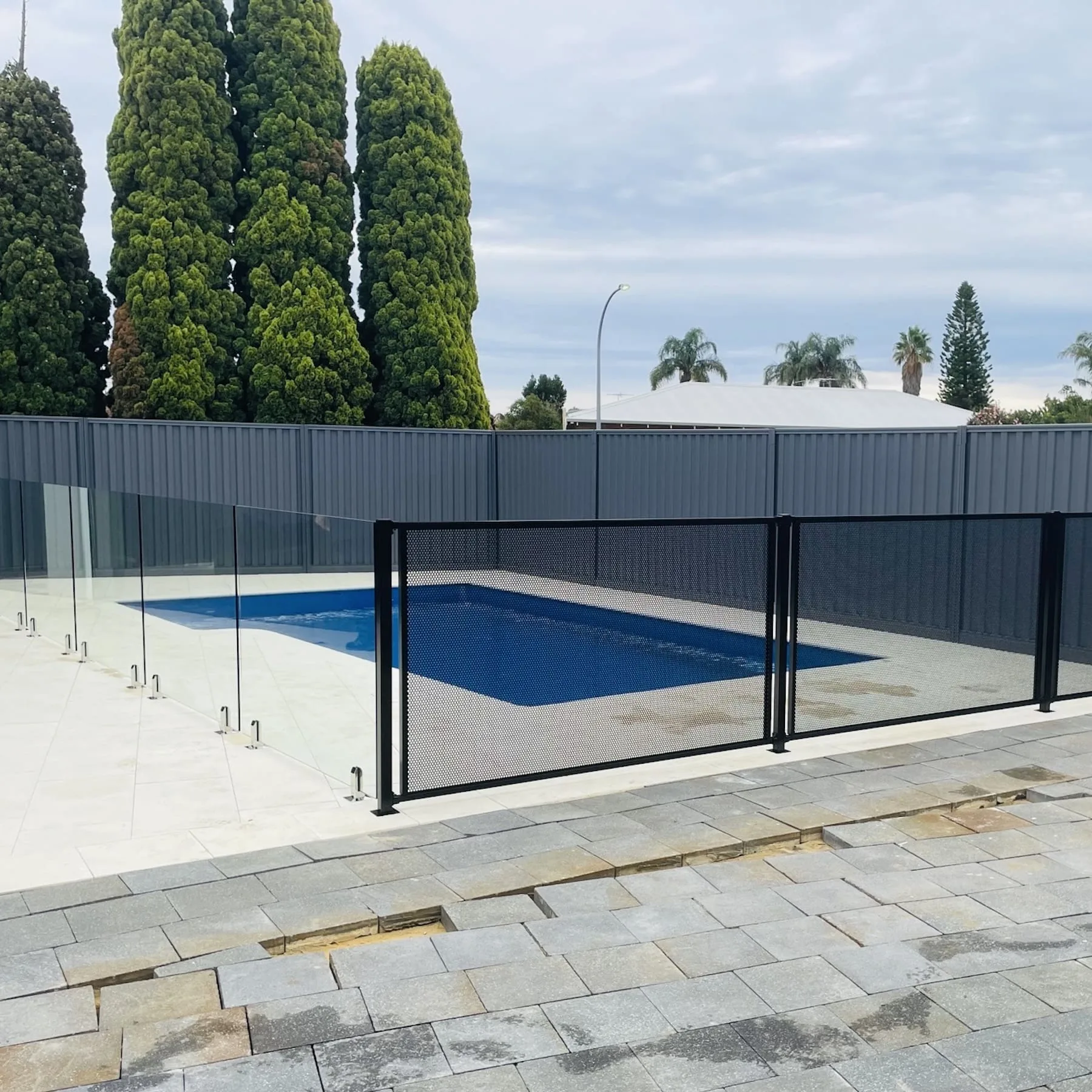 Glass pool fencing with a gate section