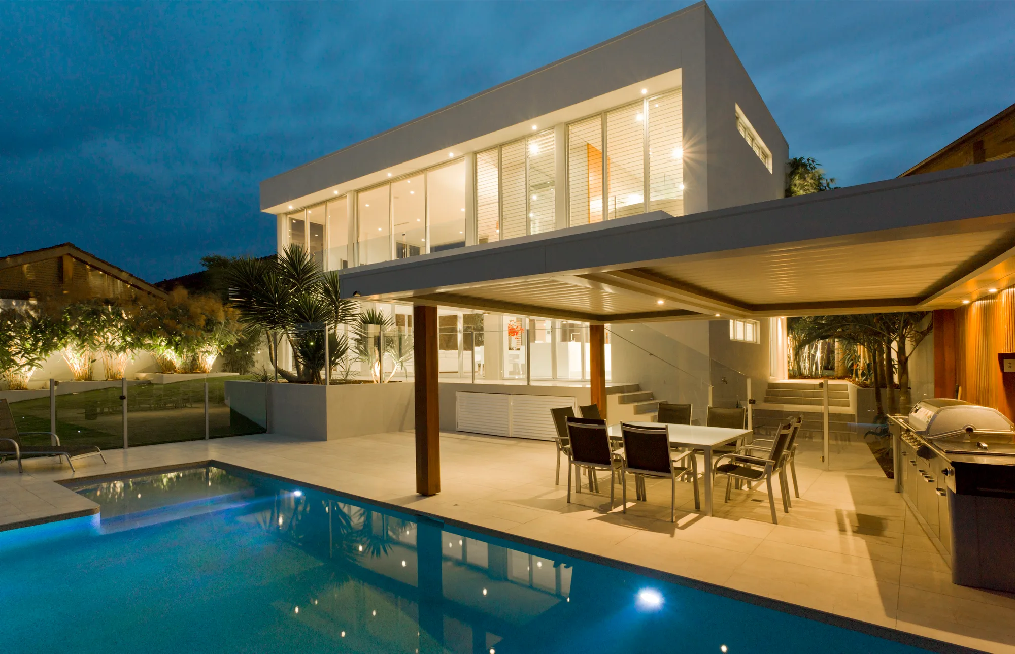 Glass balustrade around a pool at night